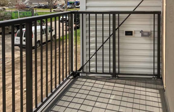 a balcony with a black iron railing