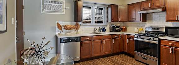 A man is lifting a child in the air while another person lies on the ground.