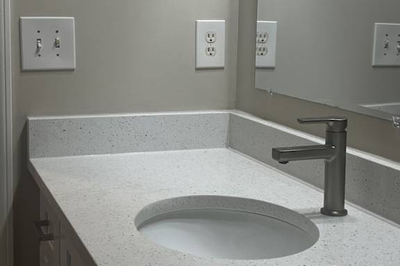 A bathroom with a sink and a mirror. at The Berkeley, Duluth, GA