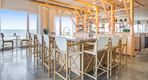 A modern dining area with wooden chairs and tables.
