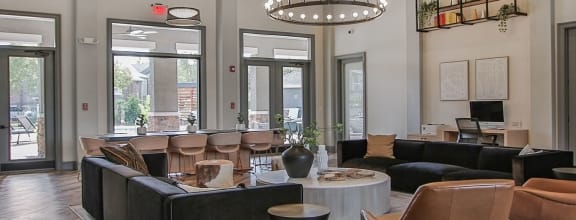 a large lobby with couches and chairs and a large chandelier at Sladestone Shadow Creek in Pearland, TX 77584
