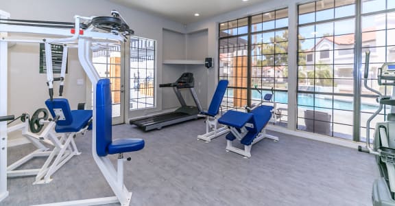 a gym with exercise equipment and a pool