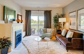 a living room with a fireplace and a balcony at Chesapeake Ridge, Maryland