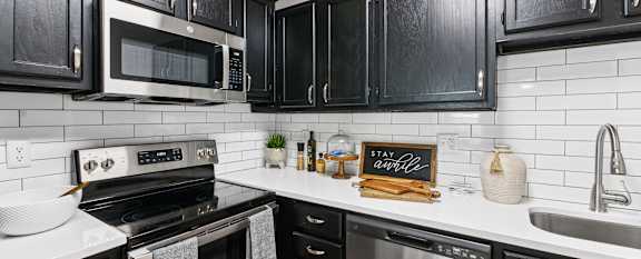 a kitchen with stainless steel appliances and white cabinets