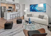 Thumbnail 18 of 78 - a living room with a couch and a table at Altis Blue Lake, Lake Worth, FL, 33467