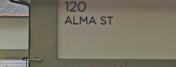 A small building with a sign that says 120 Alma St.