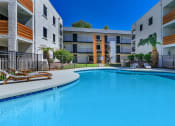 Thumbnail 21 of 22 - a large swimming pool in front of an apartment building