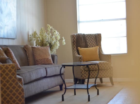 cozy living room set on hardwood style floors at Brookside Apartments in Hewitt, Texas