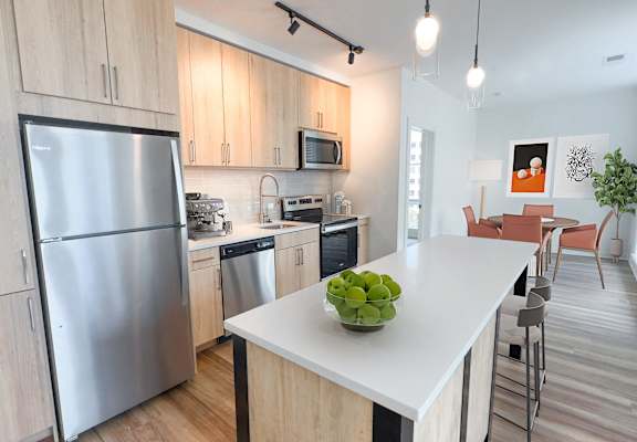 a kitchen with stainless steel appliances and a white counter top