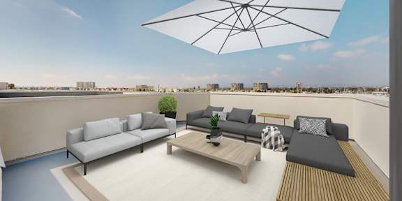 A modern outdoor patio with a large umbrella and comfortable seating. at Esprit Apartments, California, 90292