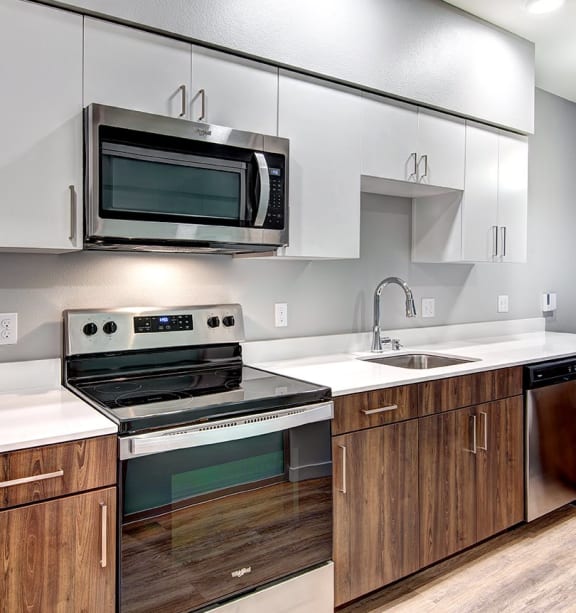 a kitchen with stainless steel appliances and white cabinets