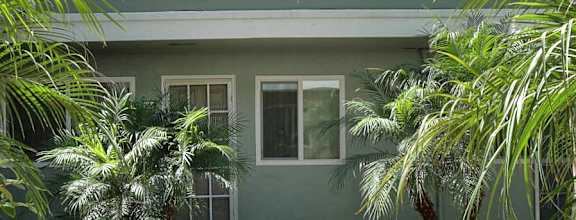 A two-story apartment building with a garage.