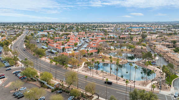 an aerial view of a city with a lake and cars on the street at San Montego Apartments, Mesa, AZ, 85206