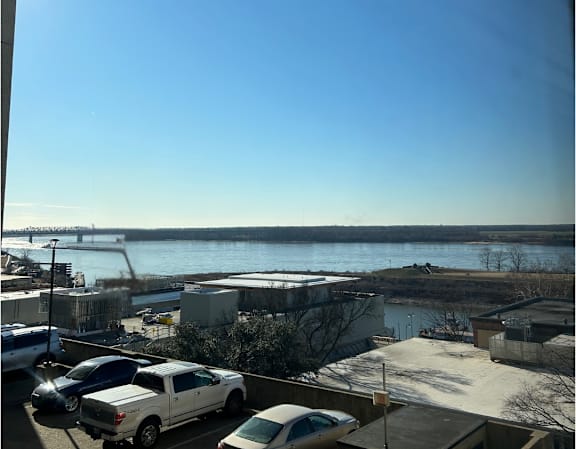 A view of a river from a high vantage point with a clear blue sky.