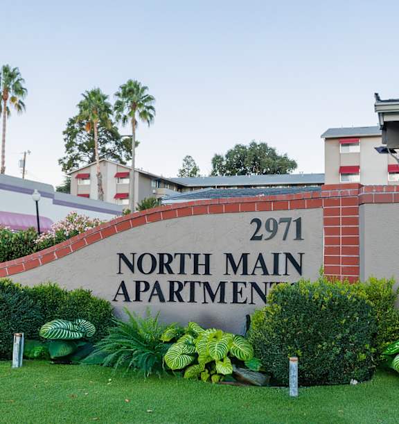 A sign for North Main Apartment 2971 is displayed in front of a building.