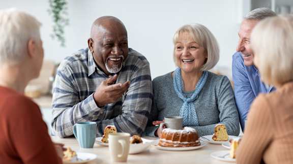 a group of people sitting around a table eating cake at The Carillon, Greensboro, NC, 27455