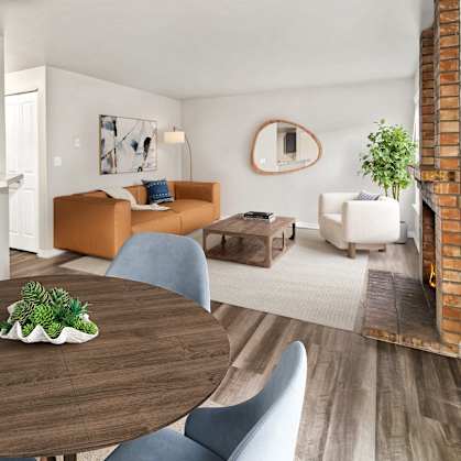 A modern dining room with a wooden table and blue chairs.