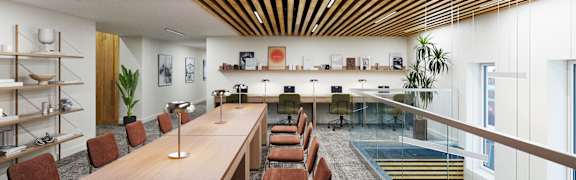 A conference room with a long table and chairs.