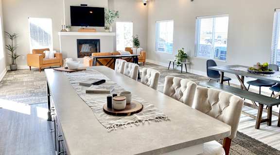 an open living room and dining room with a large table and chairs