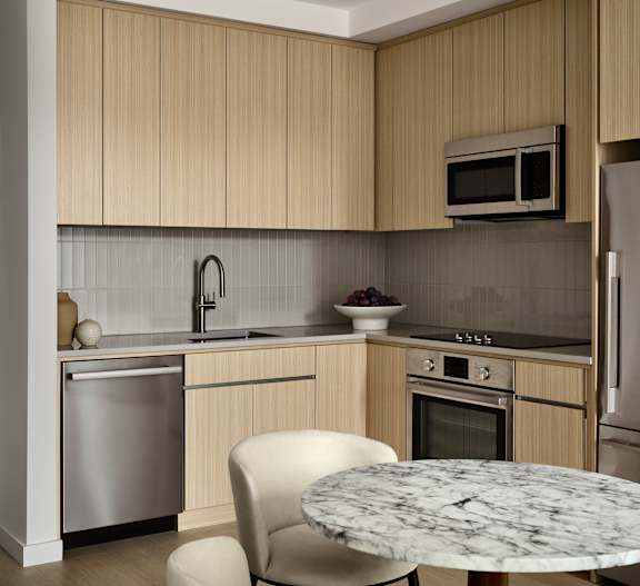 A modern kitchen with a dining table and chairs.