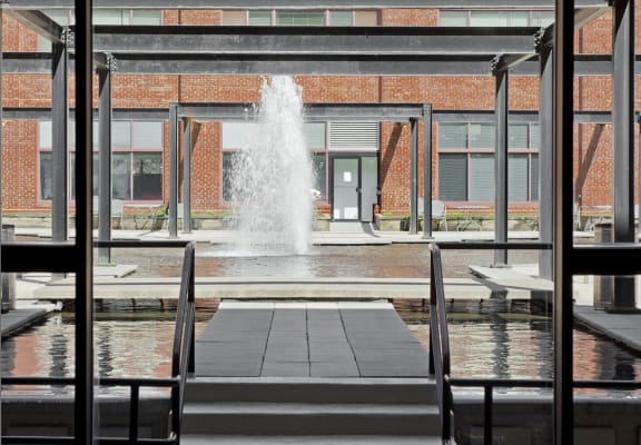 the view of the fountain through the windows of a building at Tindeco Wharf, Baltimore, MD