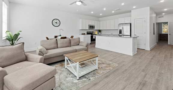 A modern living room with a white ceiling and a wooden coffee table.