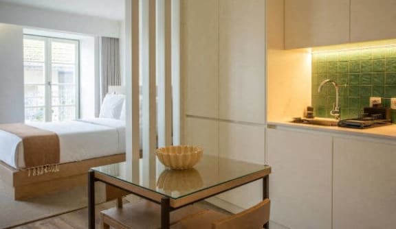 a hotel room with a bed and a table