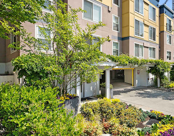 a large apartment building with a crane in the background at Sir Gallahad, Bellevue, Washington 98004