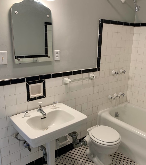 a bathroom with a sink toilet and a bath tub