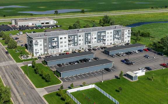 Flats on 21 apartment complex with a parking lot in front.