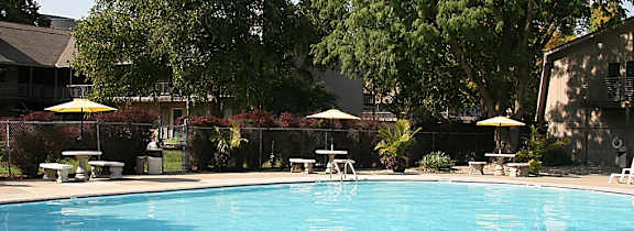 A swimming pool at Eden West, surrounded by a calm and inviting atmosphere.