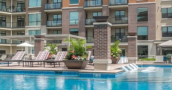 a large swimming pool with buildings in the background at The Royale at CityPlace, Kansas