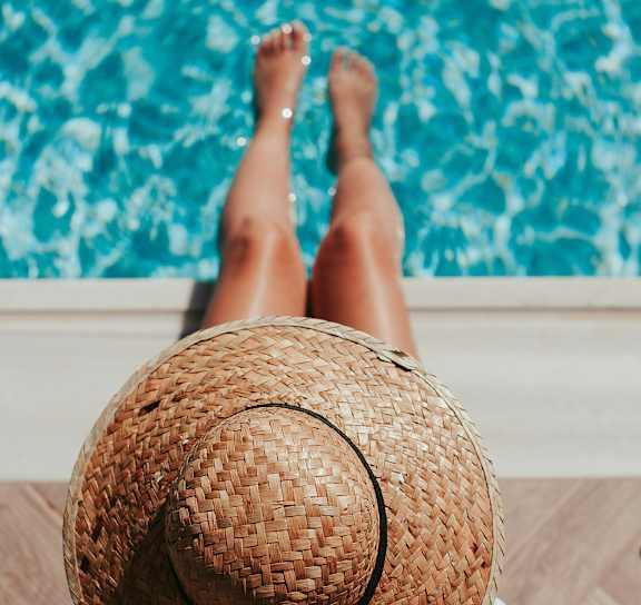 A women sitting by pool at Avia Apartments on College Blvd (Overland Park), Kansas