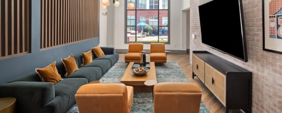 a living room with a couch and chairs and a television