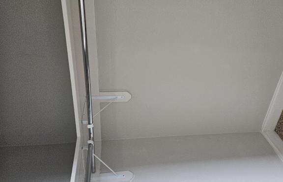 A white bathroom with a brown carpet.