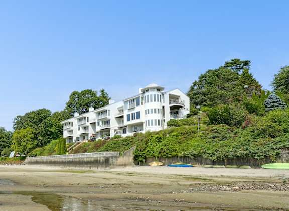 A beach with a building in the background.