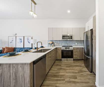 A modern kitchen with wooden cabinets and stainless steel appliances.