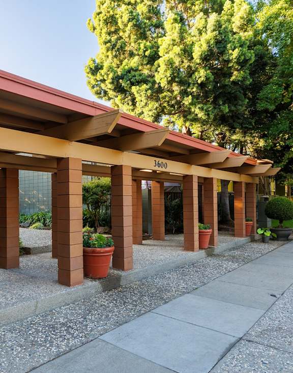 A gravel path leads to a modern house.