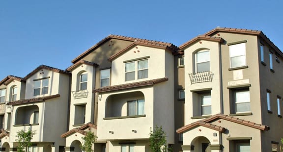 a row of houses with a sidewalk in front of them