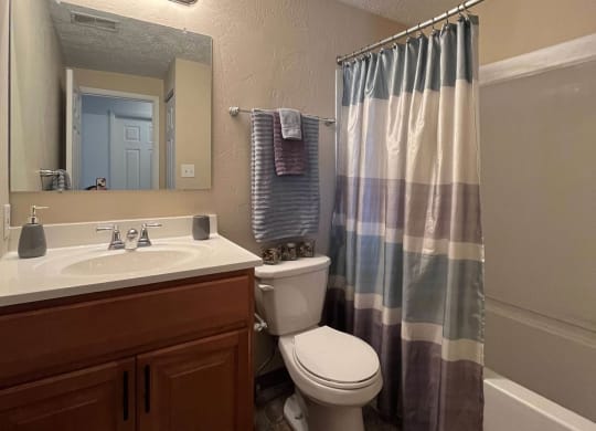 a bathroom with a toilet sink and bathtub at Monroeville Apartments, Monroeville, 15146