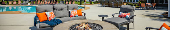 Fire Pit and seating beside Pool  at Tyler's Ridge Apartments in Carthage, NCat  Tyler's Ridge