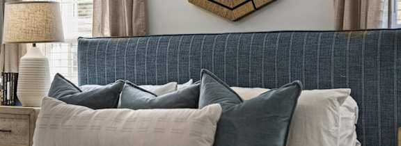 A bedroom with a bed, pillows at West Oak Apartments, Wake Forest, NC