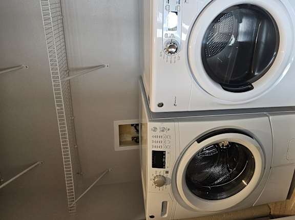 A washing machine is installed in a small room.