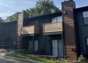 Thumbnail 19 of 27 - a picture of a black apartment building with a blue sky in the background at The Lodge Apartments, Tulsa Oklahoma