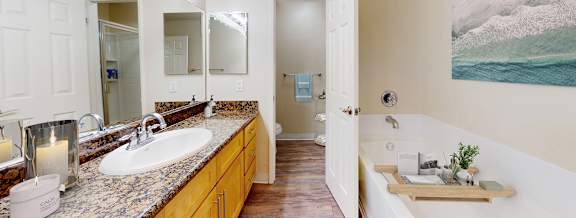 A bathroom with a large mirror and a white sink.