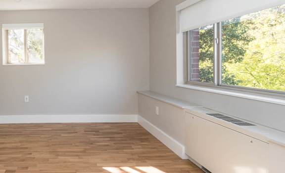 Bedroom with custom closets and large picture windows