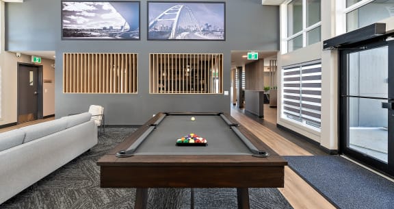 a games room with a pool table and a television