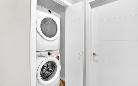 A white washing machine and dryer in a small laundry room.