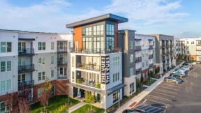 an aerial view of an apartment building with a parking lot