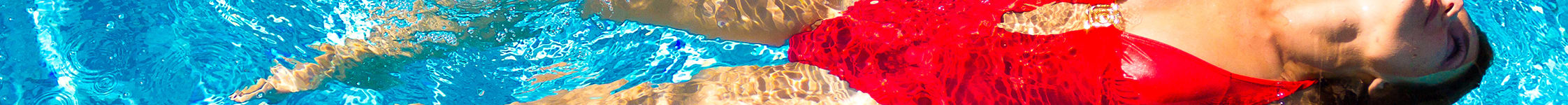 a woman in a red swimsuit swimming in a pool at Altis Blue Lake, Lake Worth